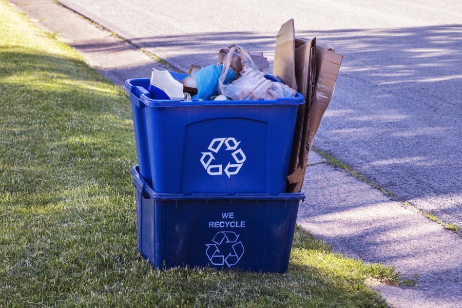 full recycling bin and trash can after the post construction