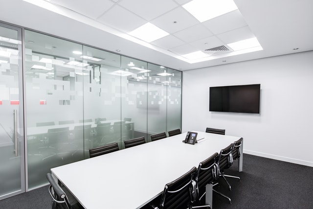 A meeting room with a clean white table.