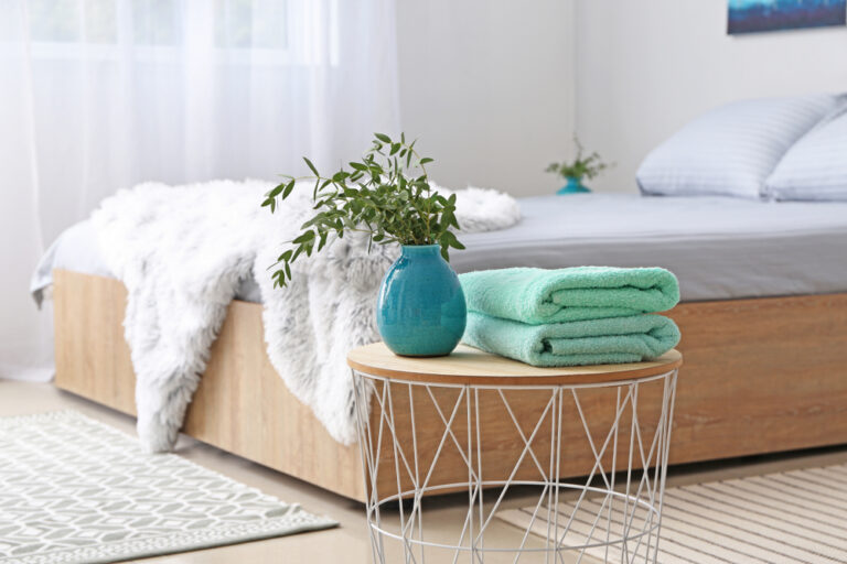 stack,of,clean,towels,on,table,in,bedroom