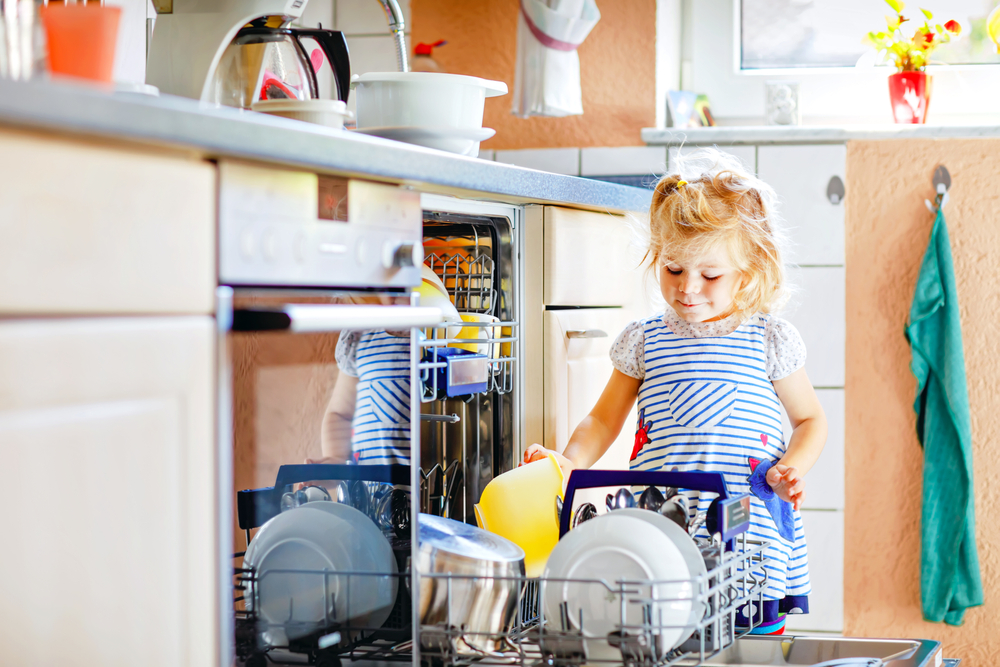 child unloading dishwasher