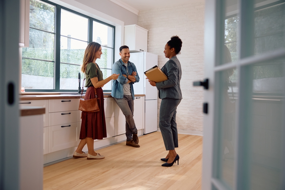 agent talking to home buyers in freshly cleaned home